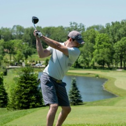 a person swinging a golf club