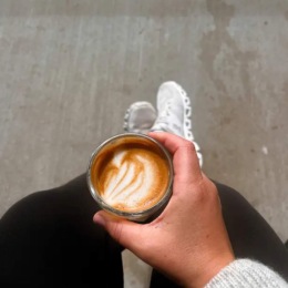a person holding a cup of coffee