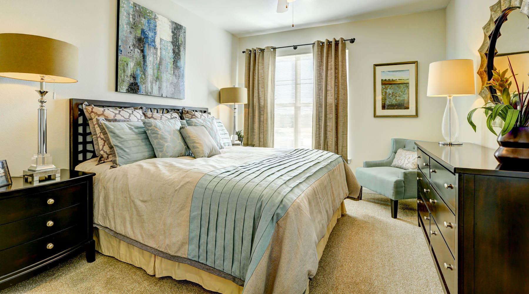 a bedroom with a fan and a bed