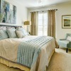 a bedroom with a fan and a bed